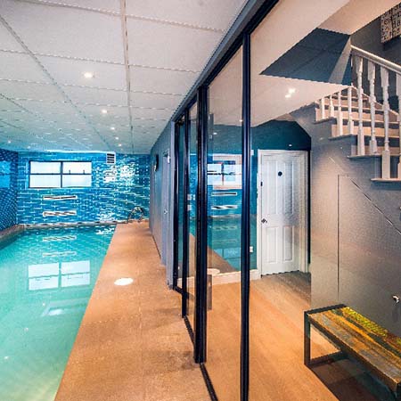 Gymnasium and pool in London basement divided in style Gymnasium and pool in London basement divided in style
