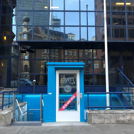 Vibrant blue external to internal access lift for gym goers Vibrant blue external to internal access lift for gym goers
