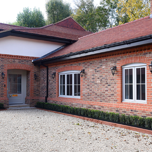 New entrance doors and flush casement windows for converted cow shed