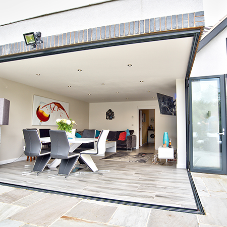 Glass bi-folding doors by Sky Bespoke Glass integrate into indoor and outdoor spaces Glass bi-folding doors by Sky Bespoke Glass integrate into indoor and outdoor spaces