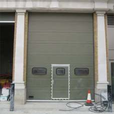 Oak-clad overhead sectional doors for the renovation of the old Territorial Army stores Oak-clad overhead sectional doors for the renovation of the old Territorial Army stores